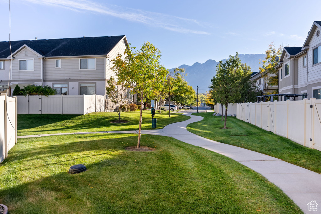 Surrounding community featuring a mountain view and a lawn