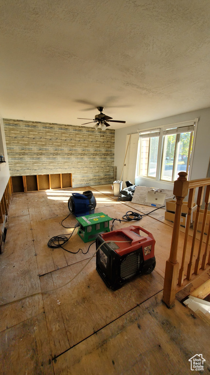 Misc room featuring ceiling fan and brick wall