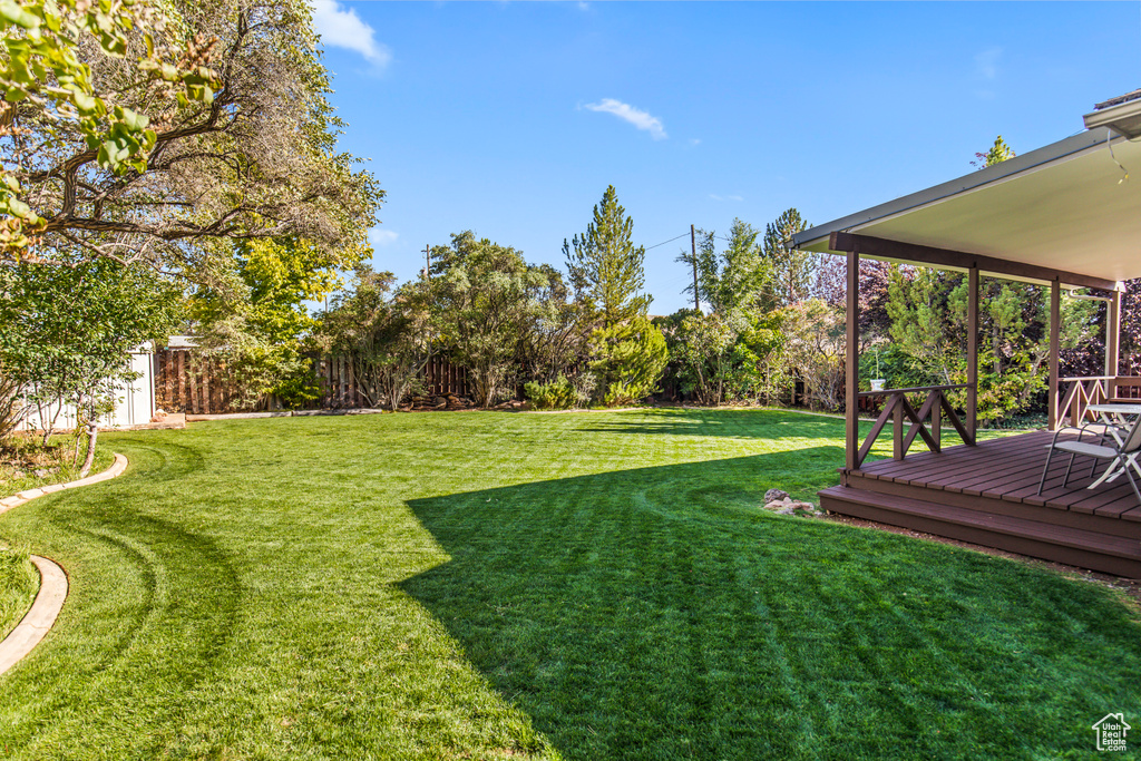 View of yard with a wooden deck