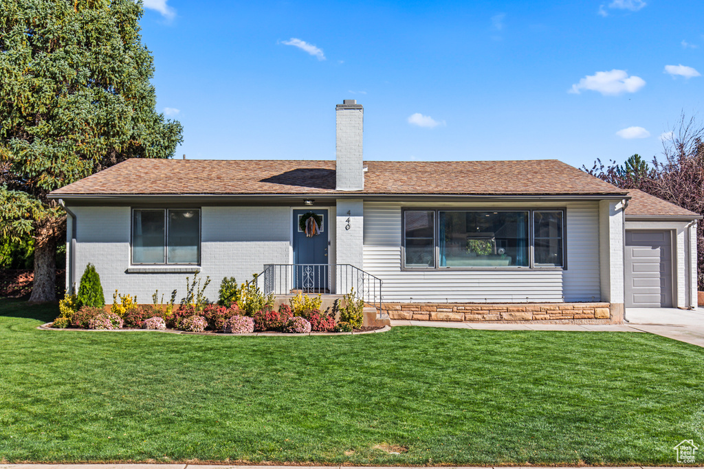 Single story home with a front yard and a garage