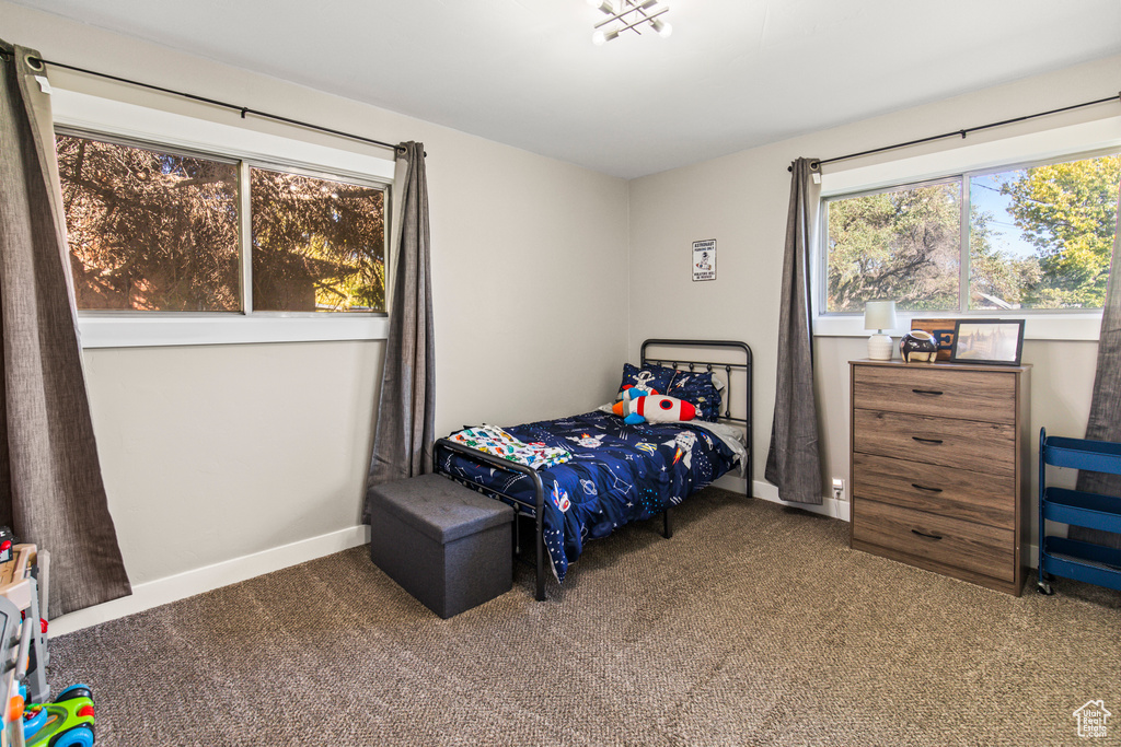 Bedroom featuring dark colored carpet