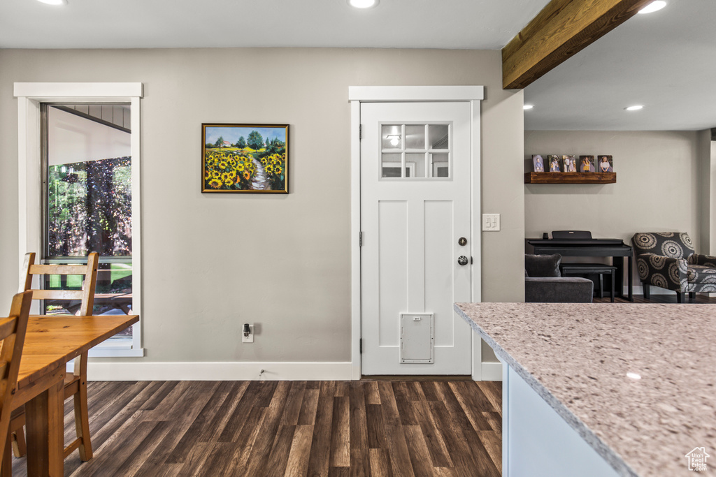 Interior space featuring dark hardwood / wood-style floors and beamed ceiling