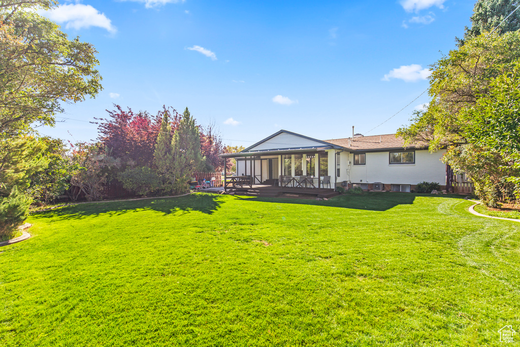 View of yard with a sunroom