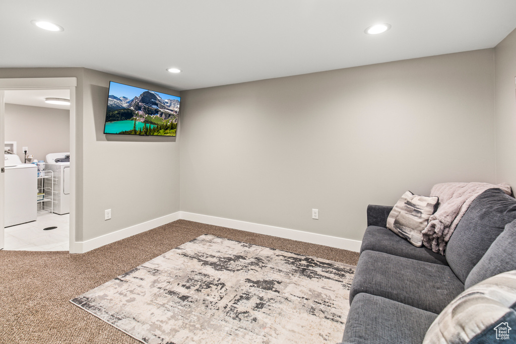 Living room with washer and dryer and carpet flooring