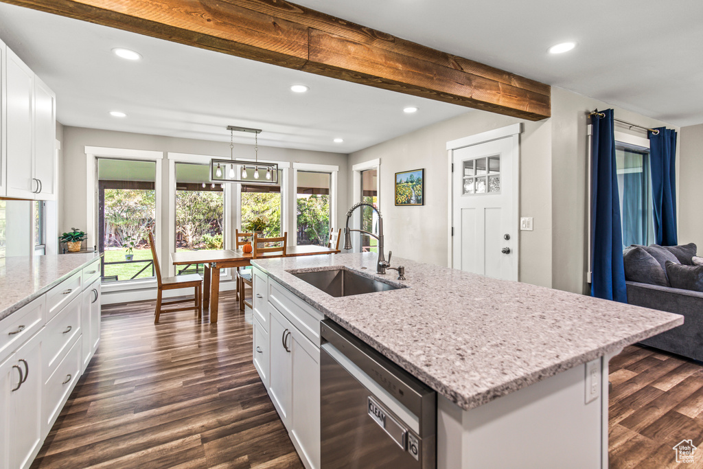 Kitchen with a center island with sink, white cabinetry, dishwasher, dark hardwood / wood-style floors, and sink