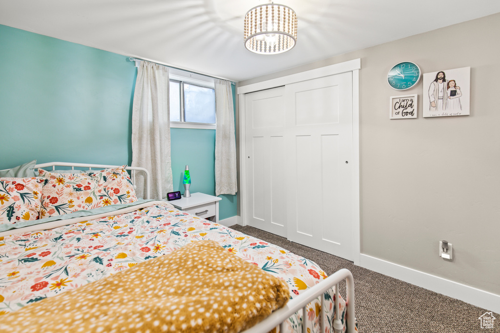 Carpeted bedroom with a notable chandelier