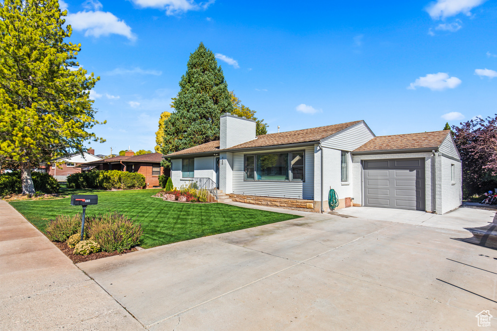 Single story home featuring a front lawn and a garage