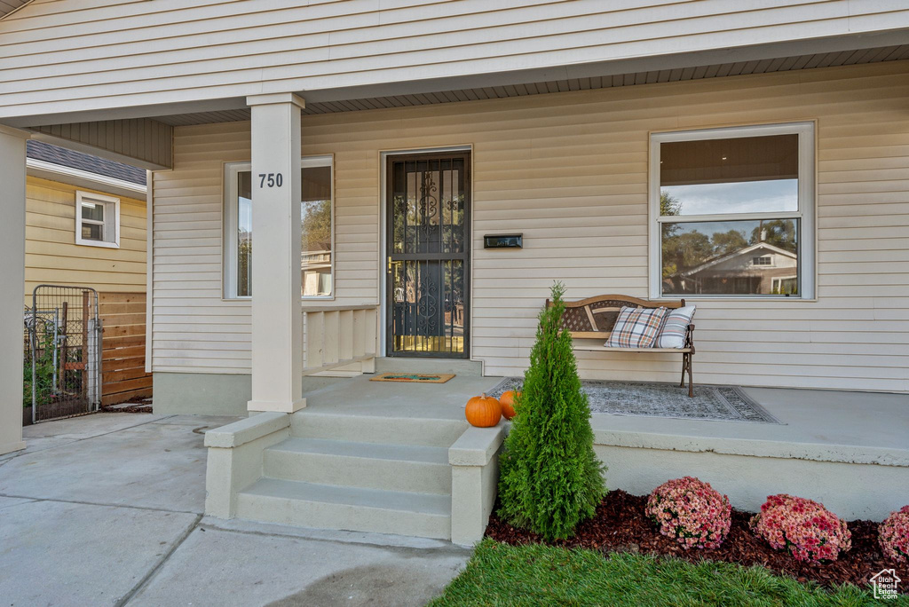 View of exterior entry with a porch