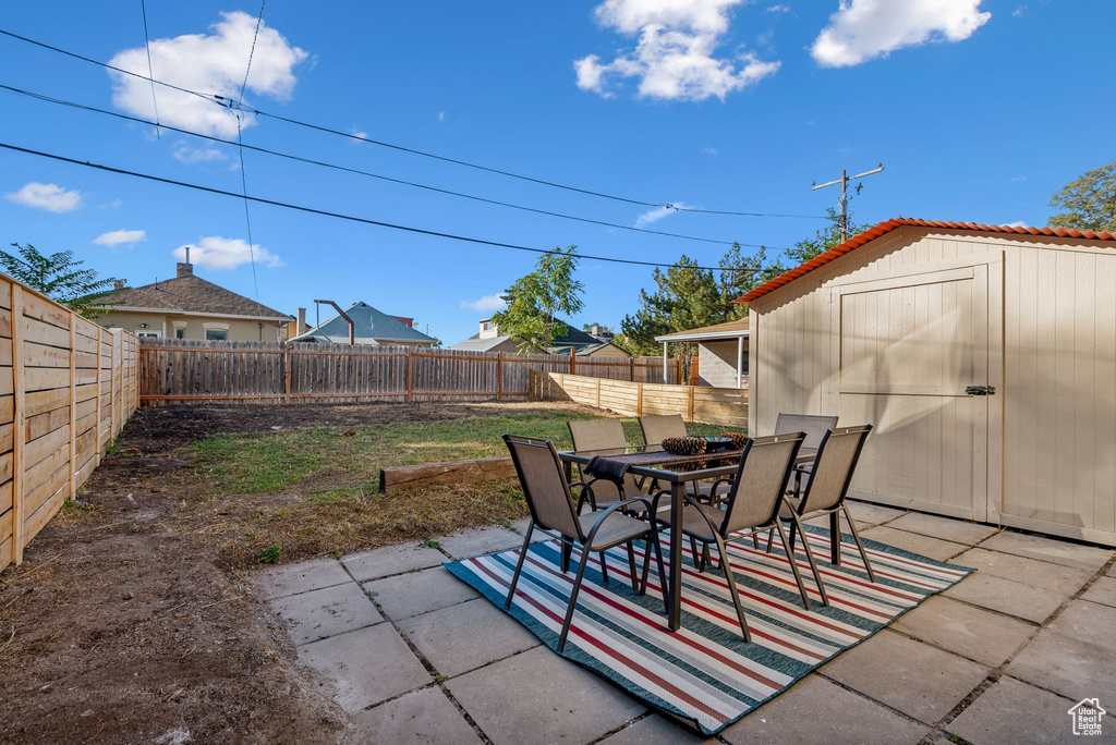 View of patio / terrace featuring a shed