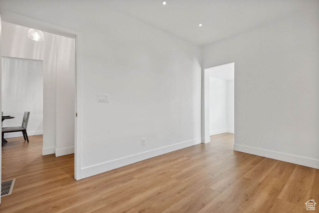 Empty room with light hardwood / wood-style floors