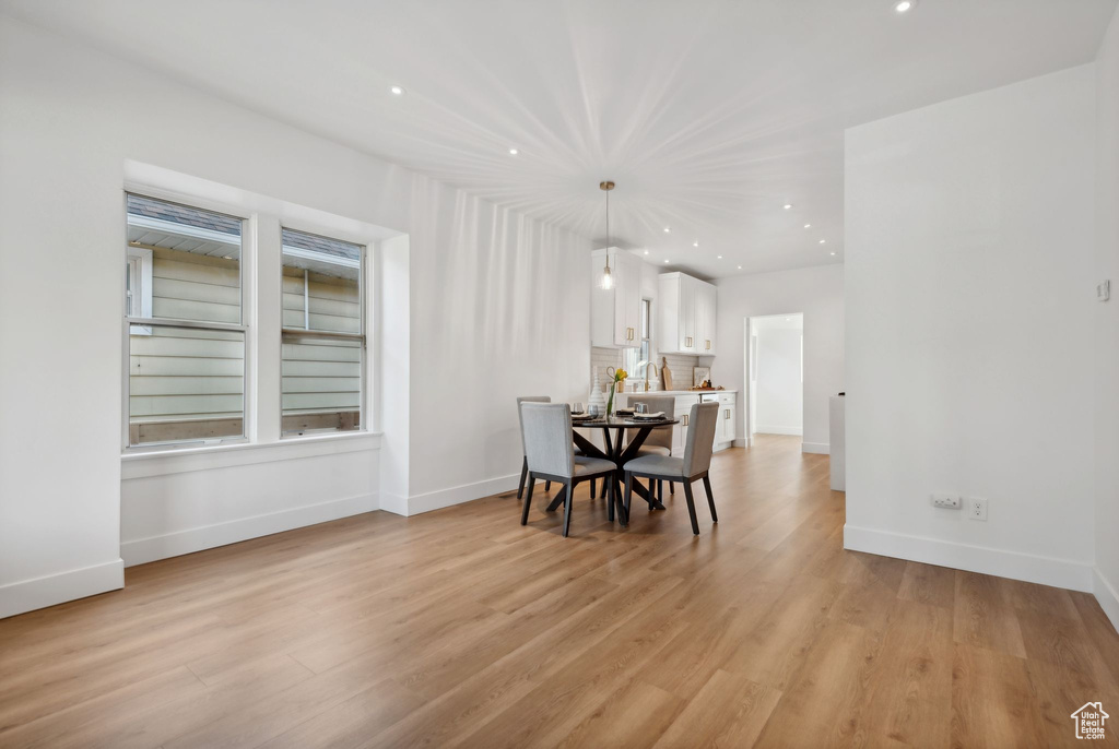 Dining room with light hardwood / wood-style flooring and built in features