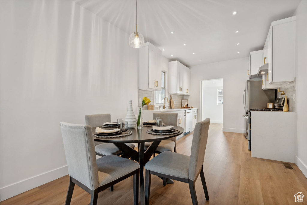 Dining area with light hardwood / wood-style floors