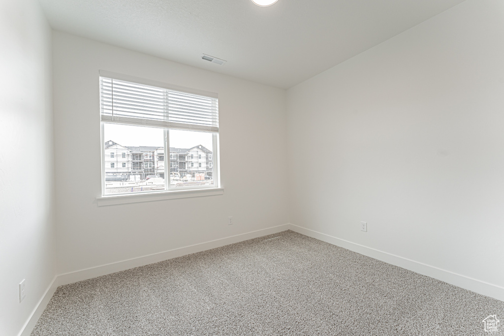 Empty room with carpet flooring and baseboards