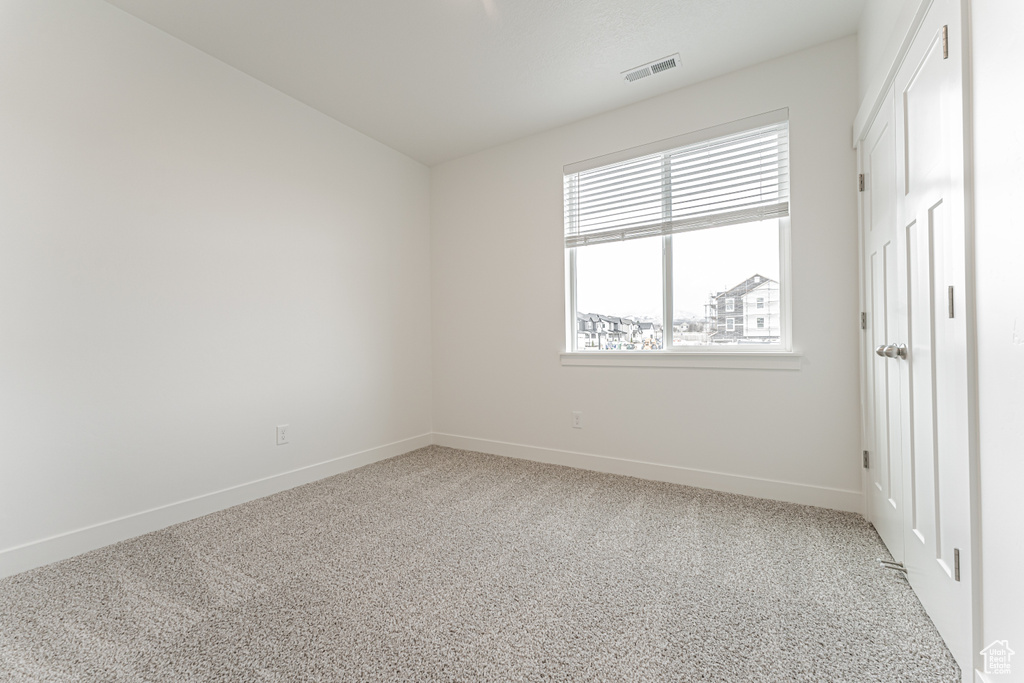 Unfurnished bedroom with baseboards and carpet floors
