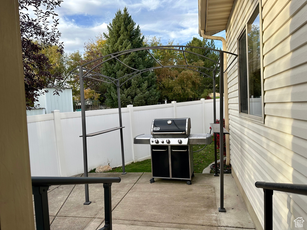 View of patio with a grill