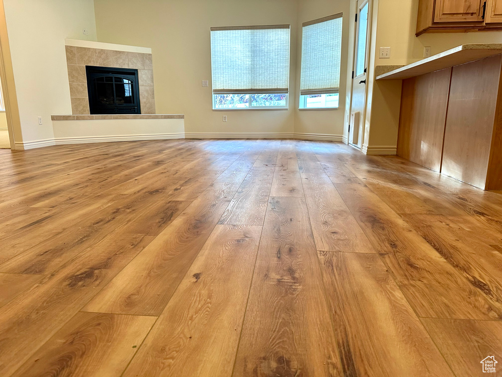 Unfurnished living room featuring light hardwood / wood-style floors and a fireplace