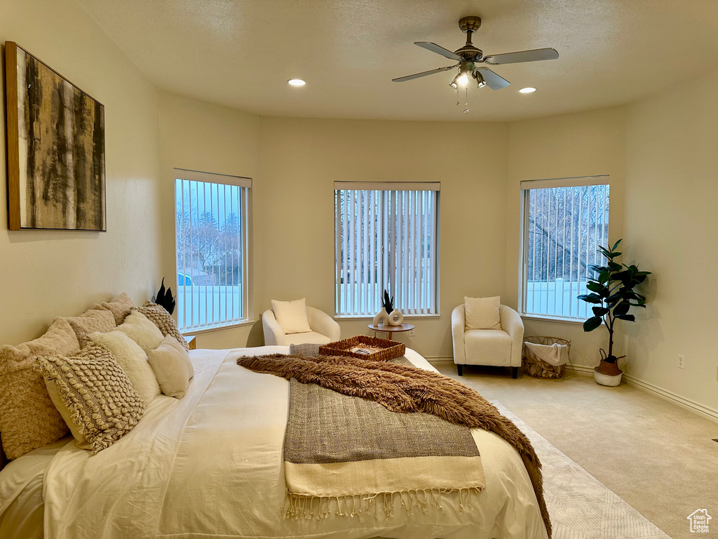 Carpeted bedroom featuring ceiling fan