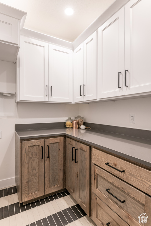 Kitchen featuring white cabinets and tile patterned flooring