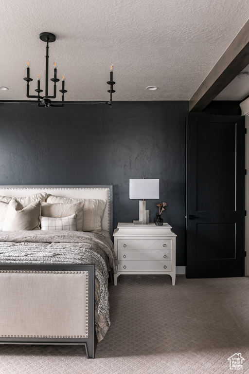 Carpeted bedroom featuring a textured ceiling