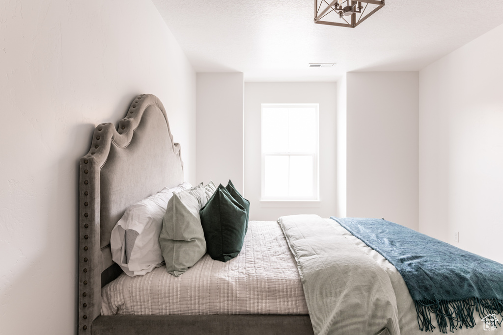 Bedroom featuring a notable chandelier