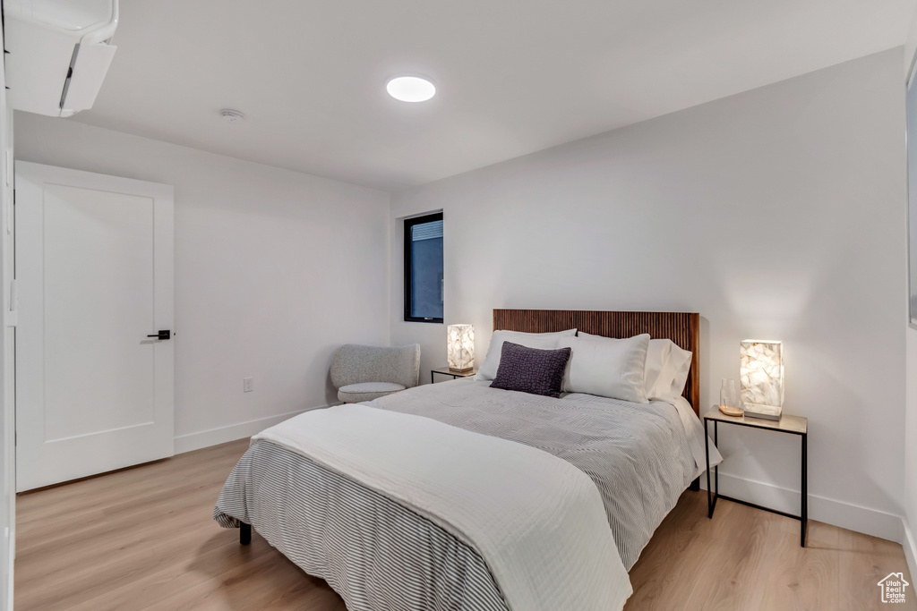 Bedroom with light hardwood / wood-style flooring