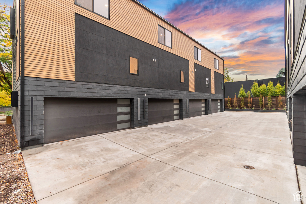 Property exterior at dusk featuring a garage