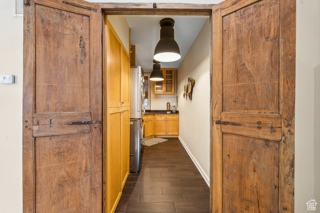 Hallway with dark hardwood / wood-style flooring