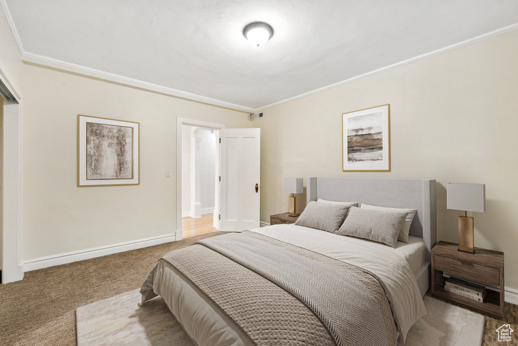 Bedroom featuring carpet flooring and ornamental molding