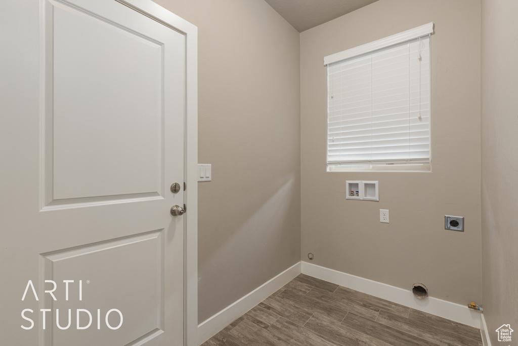 Clothes washing area featuring gas dryer hookup, hookup for a washing machine, hardwood / wood-style flooring, and hookup for an electric dryer