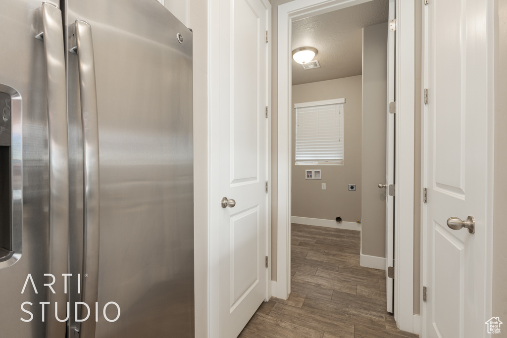 Hall featuring a textured ceiling and dark hardwood / wood-style flooring