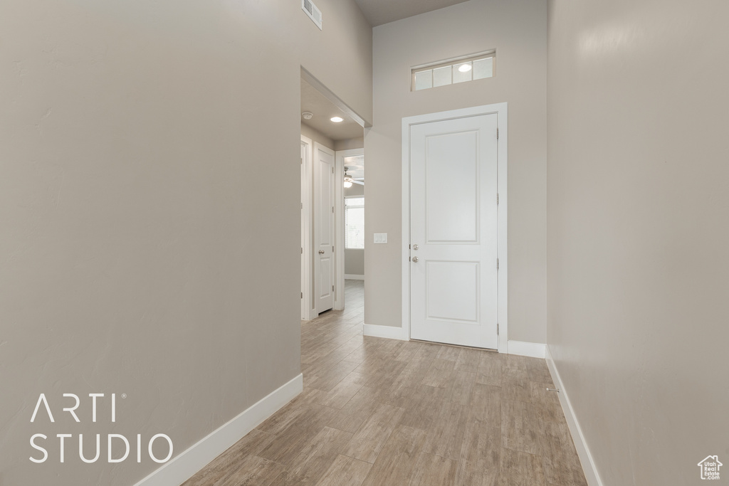 Corridor featuring light wood-type flooring