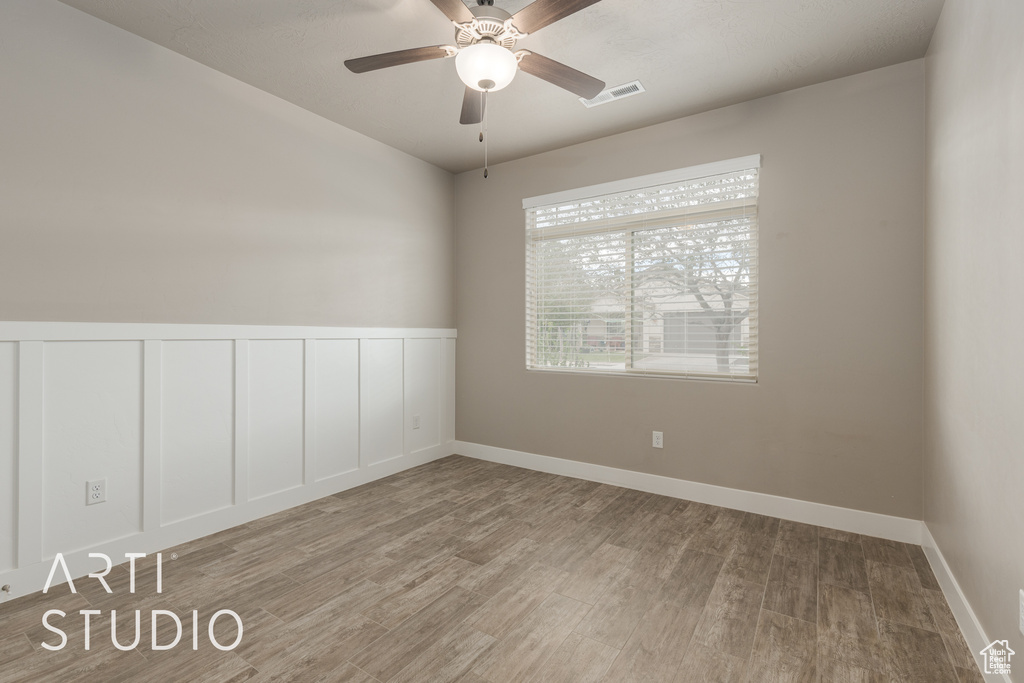 Spare room featuring ceiling fan and light wood-type flooring