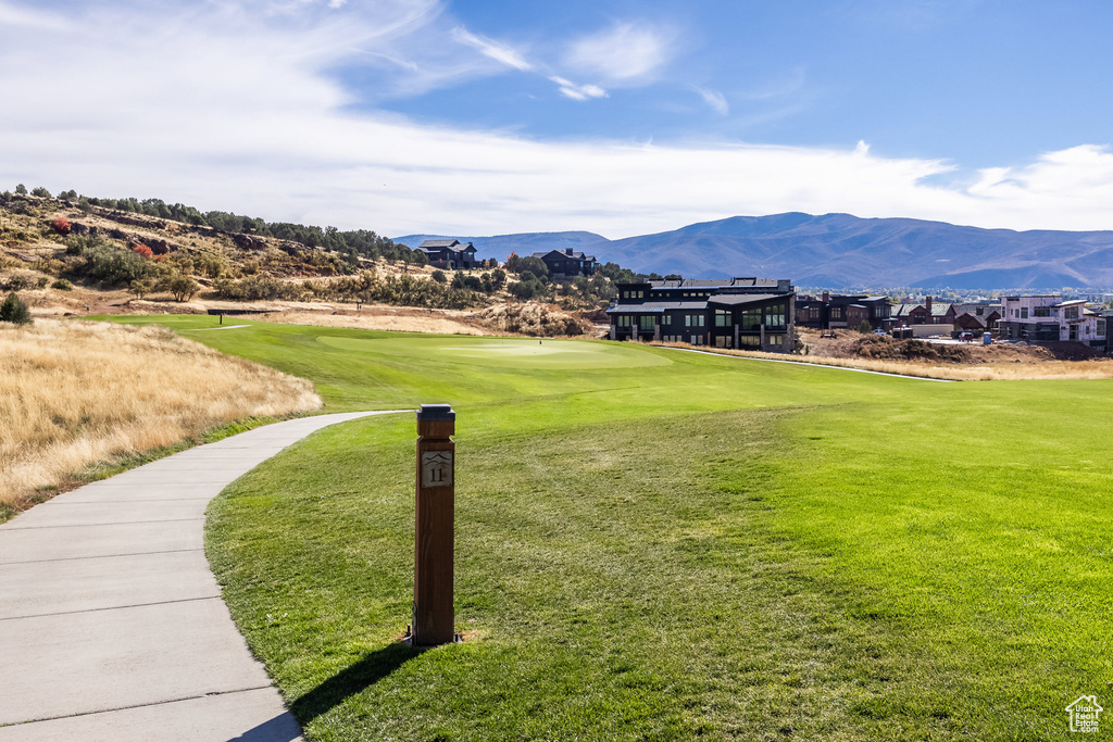 View of home's community featuring a mountain view and a lawn