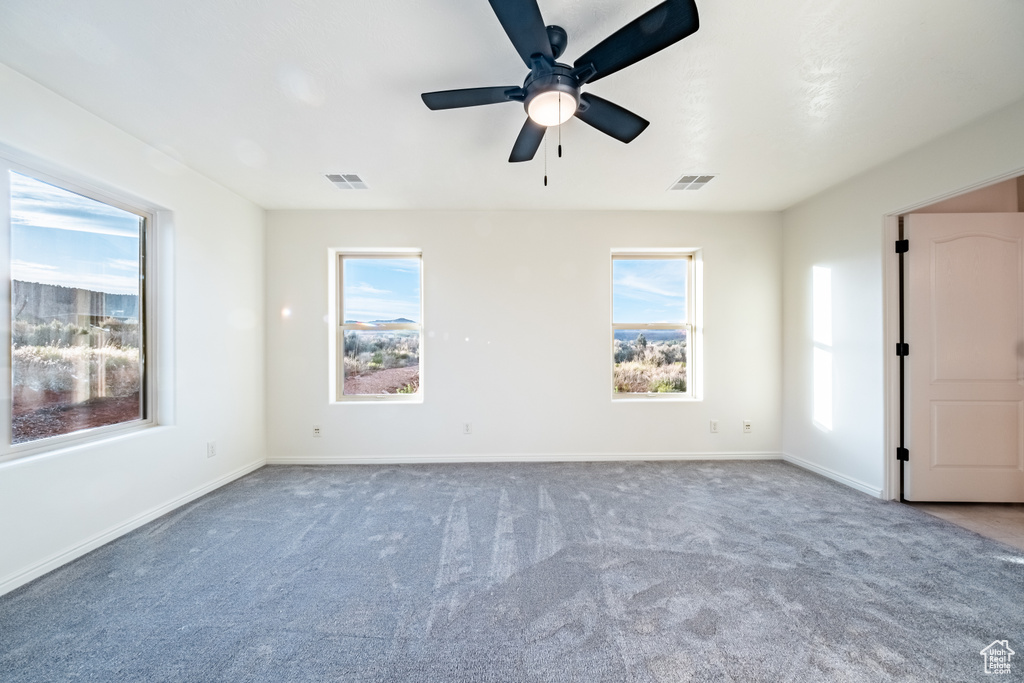 Spare room with carpet floors and ceiling fan