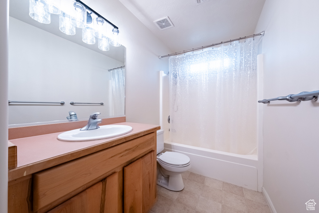 Full bathroom with vanity, toilet, and shower / bathtub combination with curtain