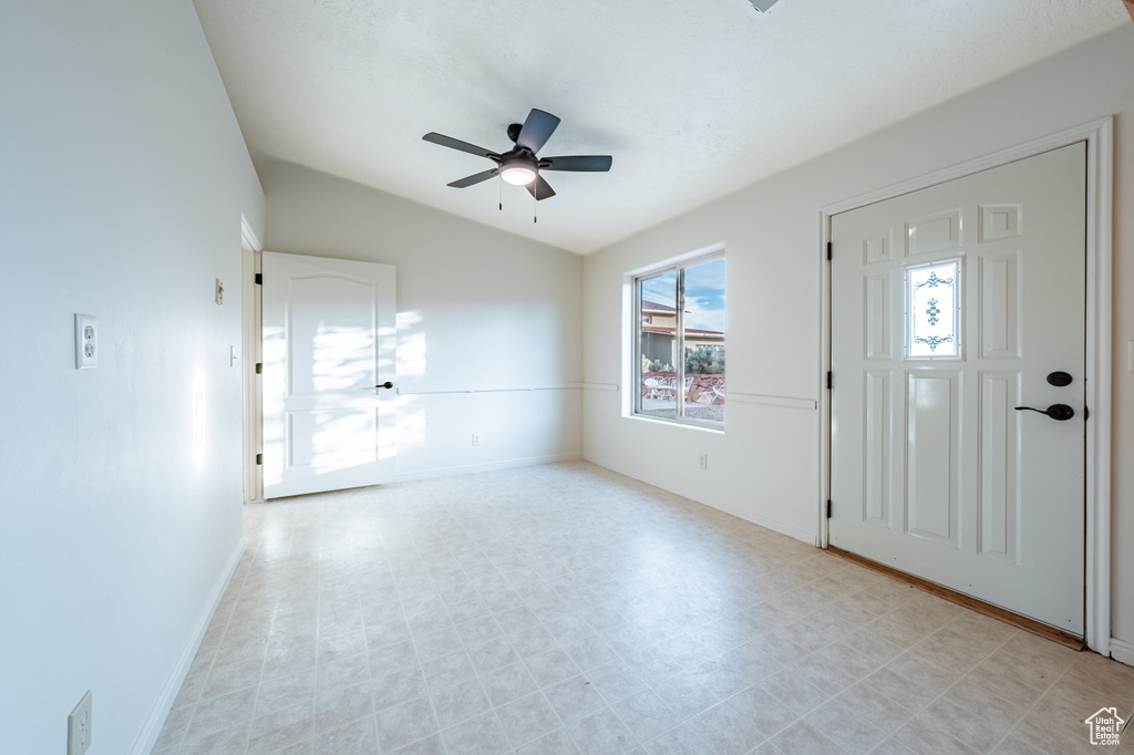 Foyer entrance featuring lofted ceiling and ceiling fan