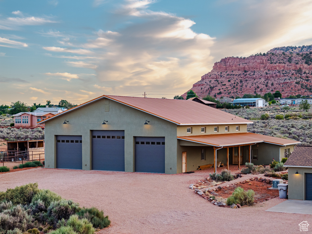 View of front of house with a mountain view and a garage