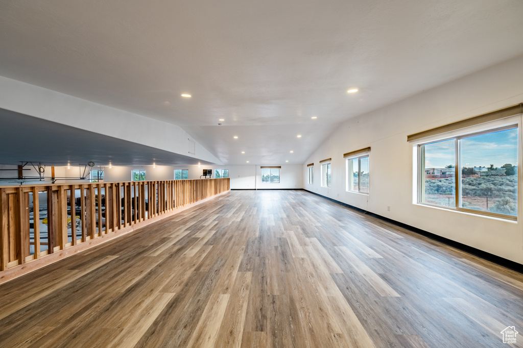 Spare room with lofted ceiling and light hardwood / wood-style flooring