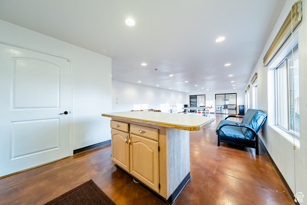 Kitchen featuring light brown cabinetry and a center island