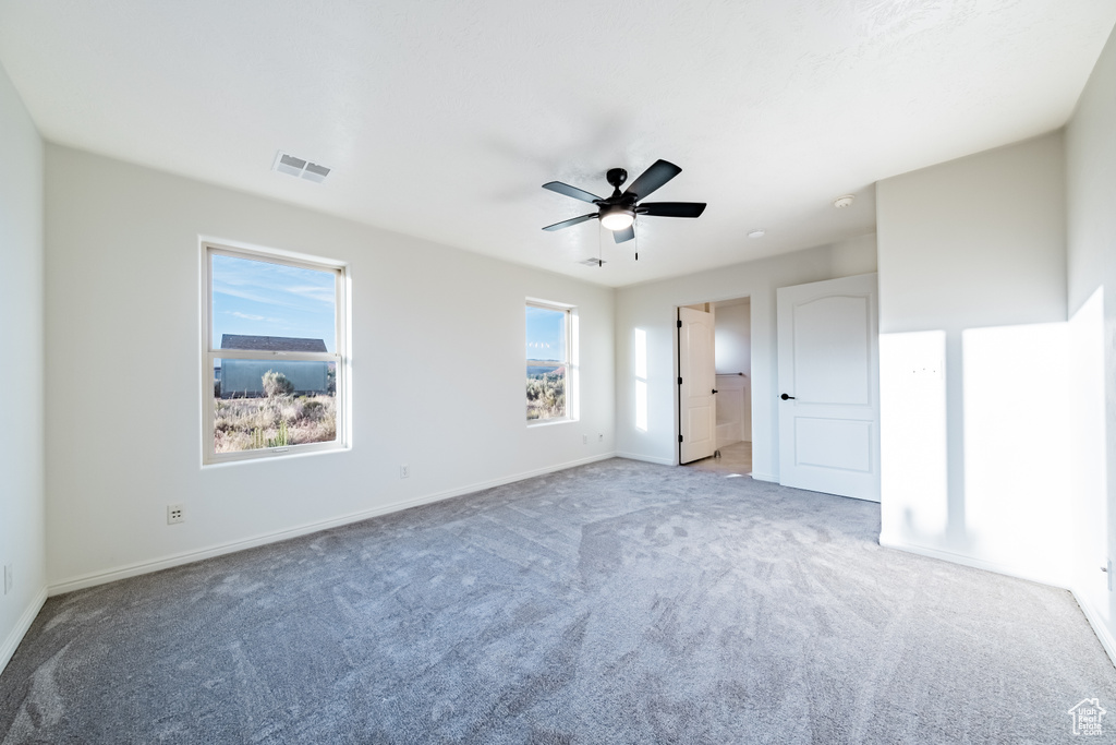 Unfurnished bedroom featuring ceiling fan and carpet flooring