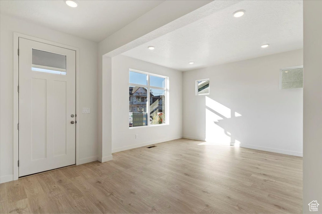 Entrance foyer with light hardwood / wood-style floors