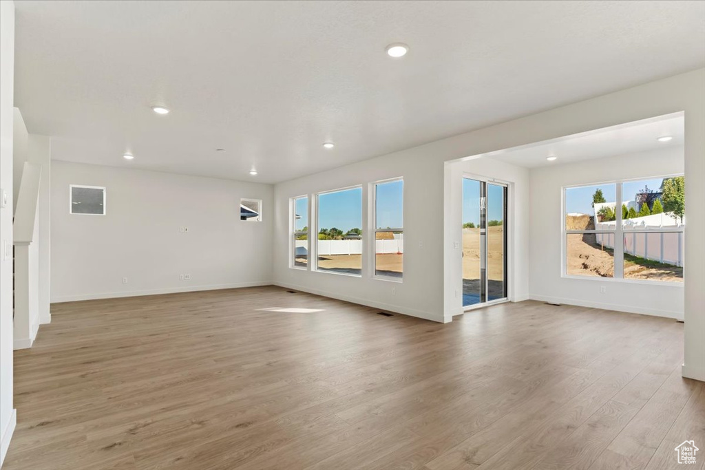 Empty room featuring light hardwood / wood-style floors and a wealth of natural light