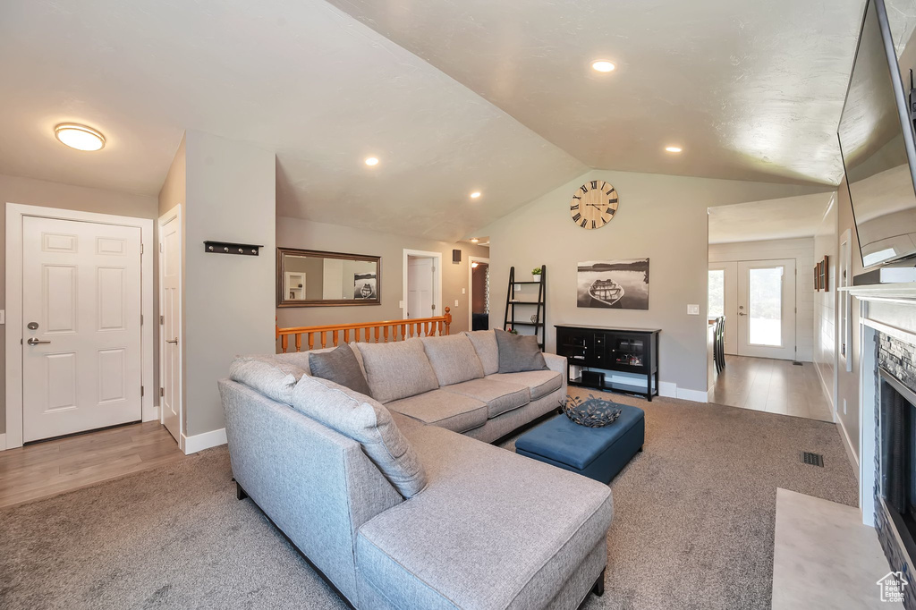 Living room featuring light hardwood / wood-style floors and lofted ceiling