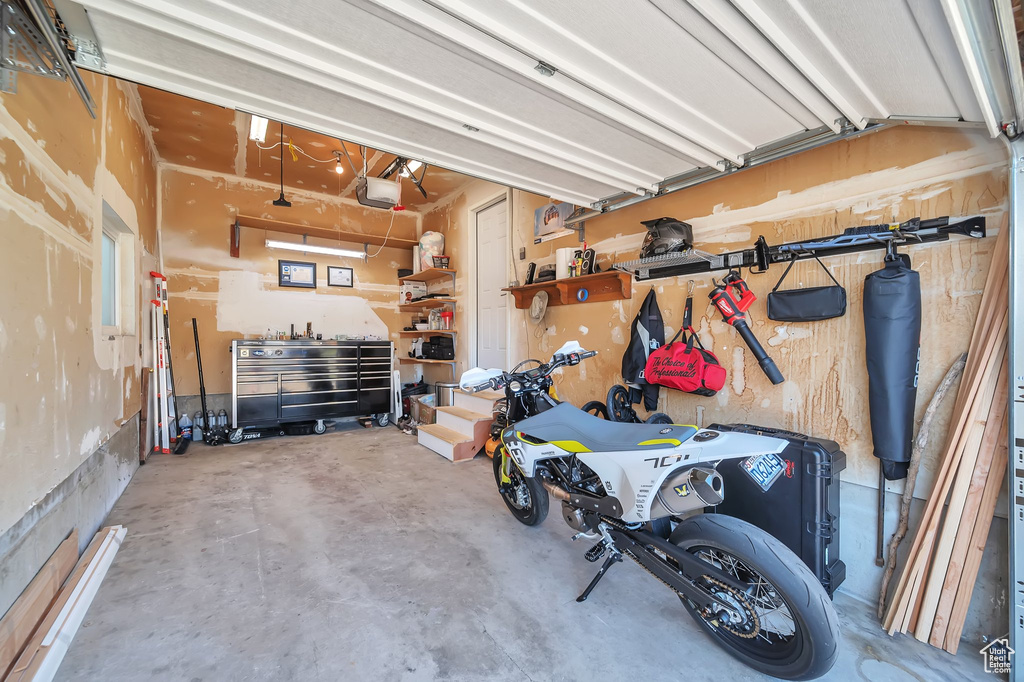 Garage with a garage door opener and a workshop area