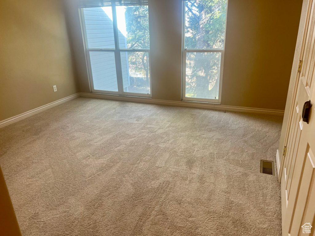 Empty room with light colored carpet