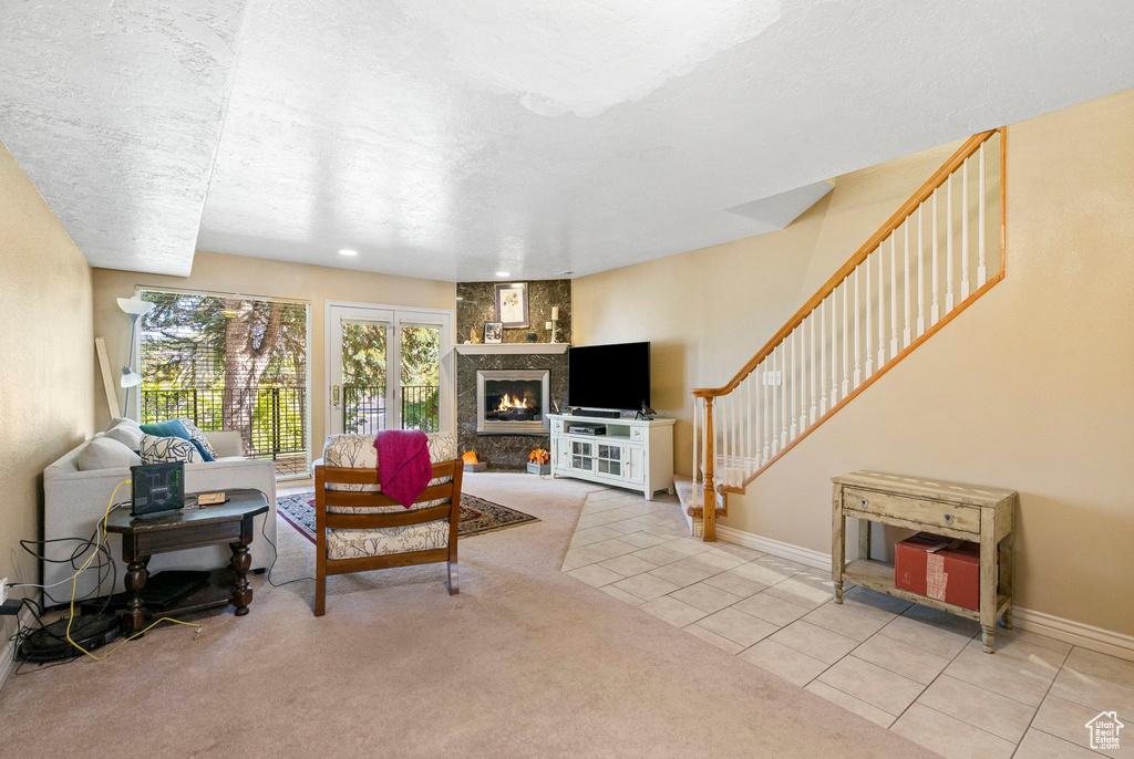 Tiled living room with a textured ceiling and a fireplace