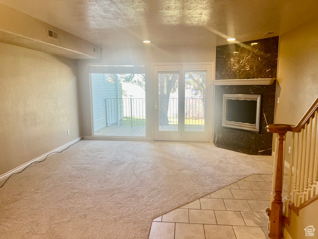 Unfurnished living room with light colored carpet