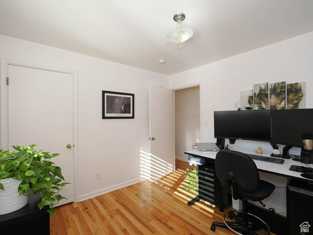 Office featuring built in desk and wood-type flooring