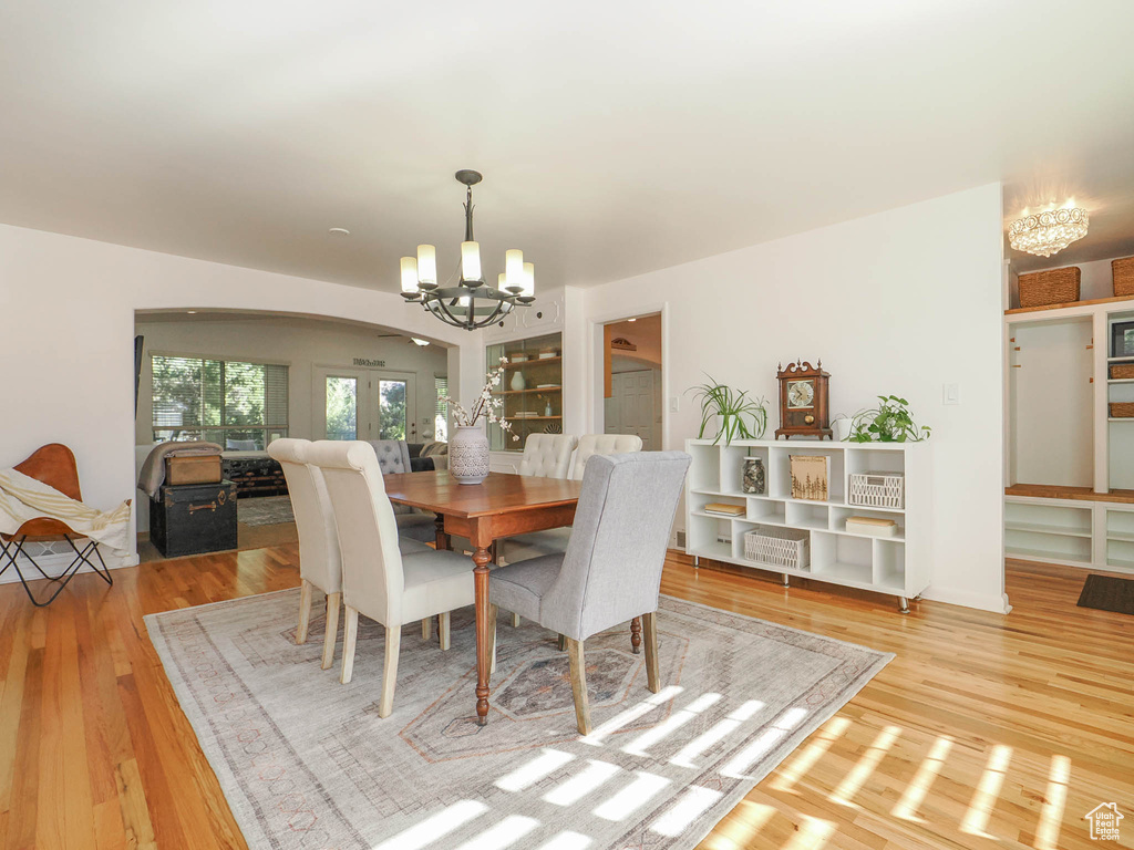 Dining space with a chandelier and light wood-type flooring