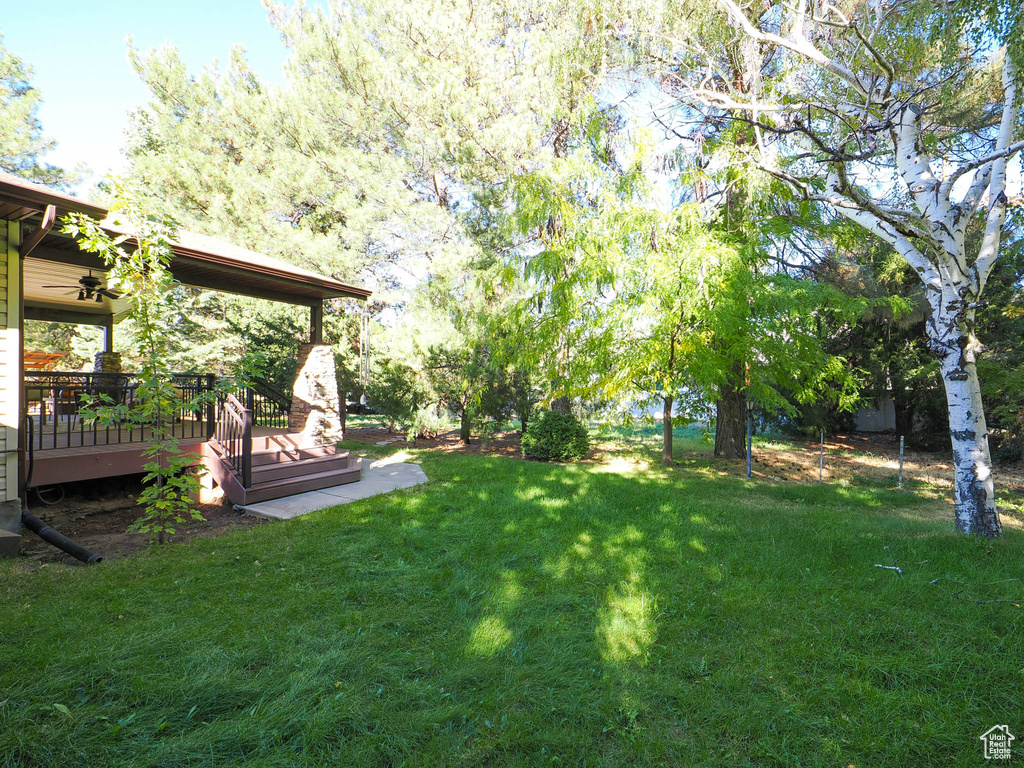 View of yard with a wooden deck